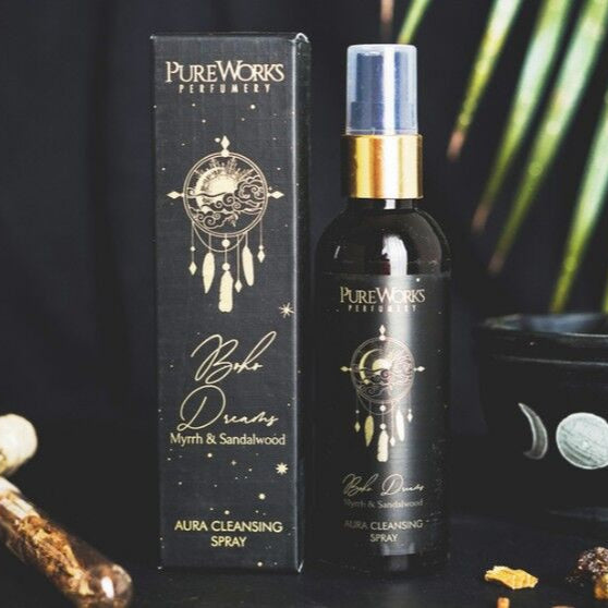 Pure Works perfume bottle and packaging with decorative items on a dark background