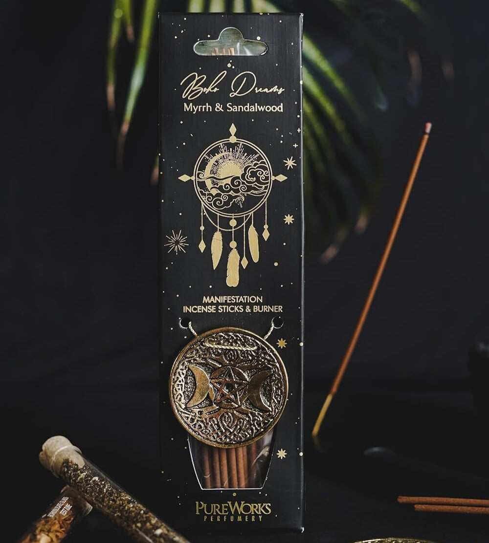 Packaged incense sticks with decorative design on a dark background