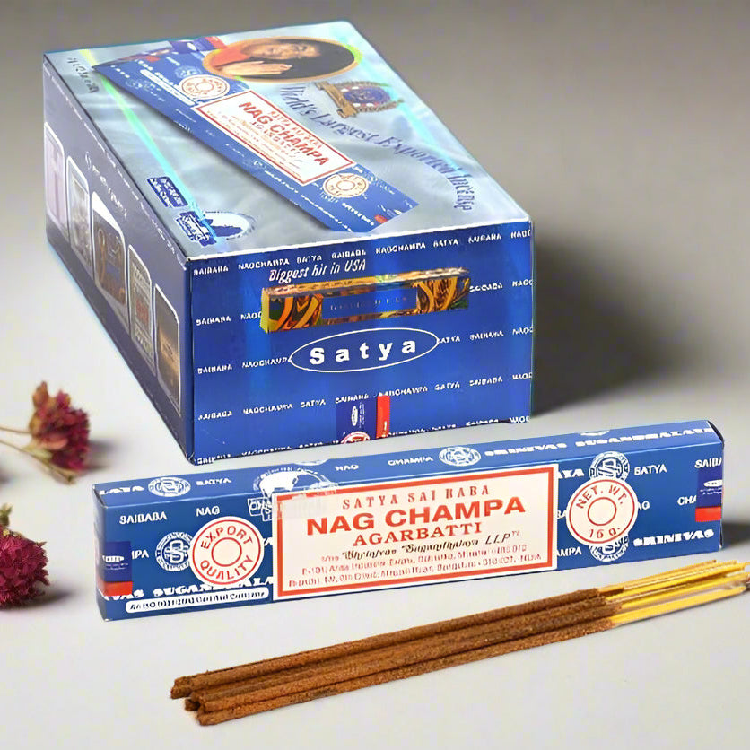 Satya Nag Champa incense sticks with packaging on a neutral background