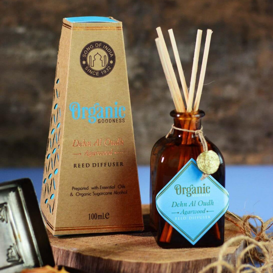 Reed diffuser set with organic packaging and bottle on a wooden surface