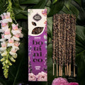 The image shows a pack of Sagrada Madre Botanical Incense with the name 'LAVENDER ROSES' written on it, alongside six incense sticks with a mix of lavender and rose petals. The packaging is predominantly white with a floral design and the product is described as hand made with natural ingredients.