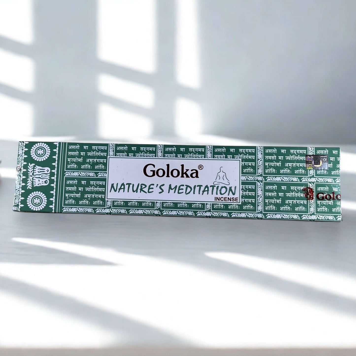 Box of Goloka Nature's Meditation incense on a white surface with sunlight casting shadows.