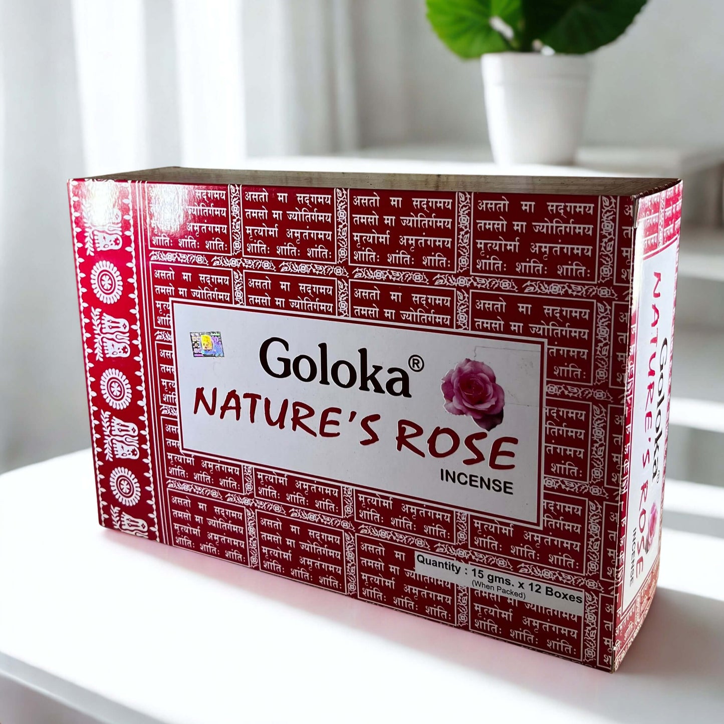 Box of Goloka Nature's Rose incense on a white surface with a plant in the background
