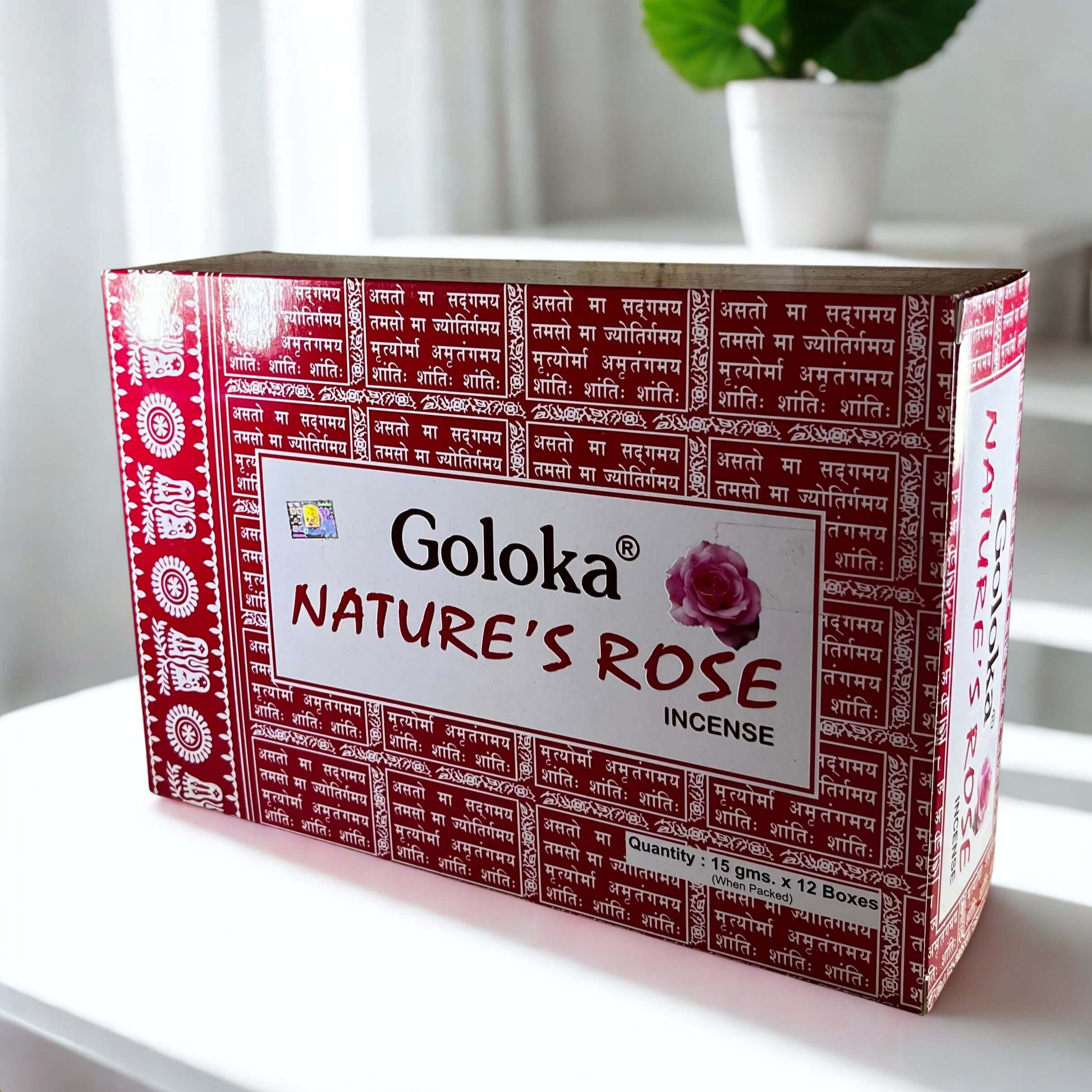 Box of Goloka Nature's Rose incense on a white surface with a plant in the background