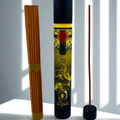 Incense stick tube with incense sticks on a white surface
