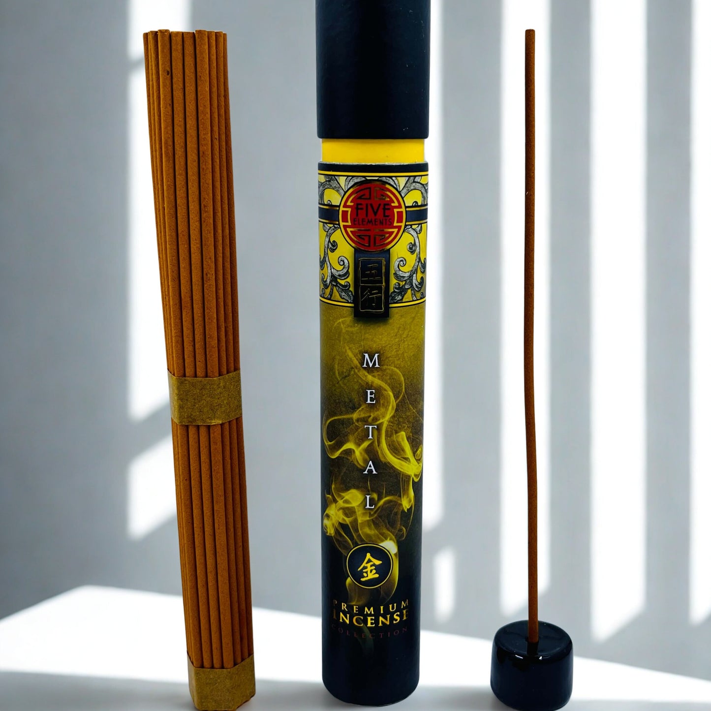 Incense stick tube with incense sticks on a white surface