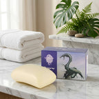 Bar of soap next to a box with a dragon design on a white background
