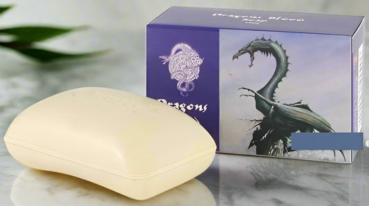 Bar of soap next to a box with a dragon design on a white background