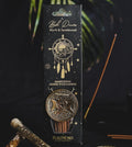 Packaged incense sticks with decorative design on a dark background