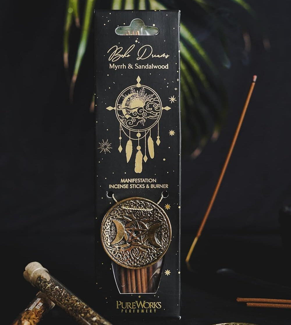 Packaged incense sticks with decorative design on a dark background