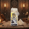 Mason jar with tarot card design on a mystical table with candles and books.