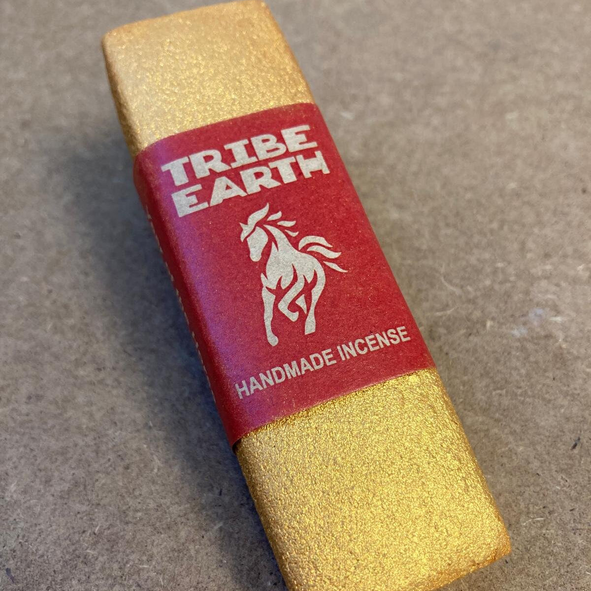 Tribe Earth handmade incense stick on a concrete surface