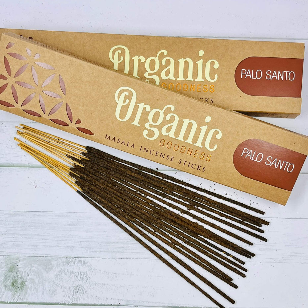 A packet of Organic Goodness Palo Santo incense sticks displayed on a wooden surface.
