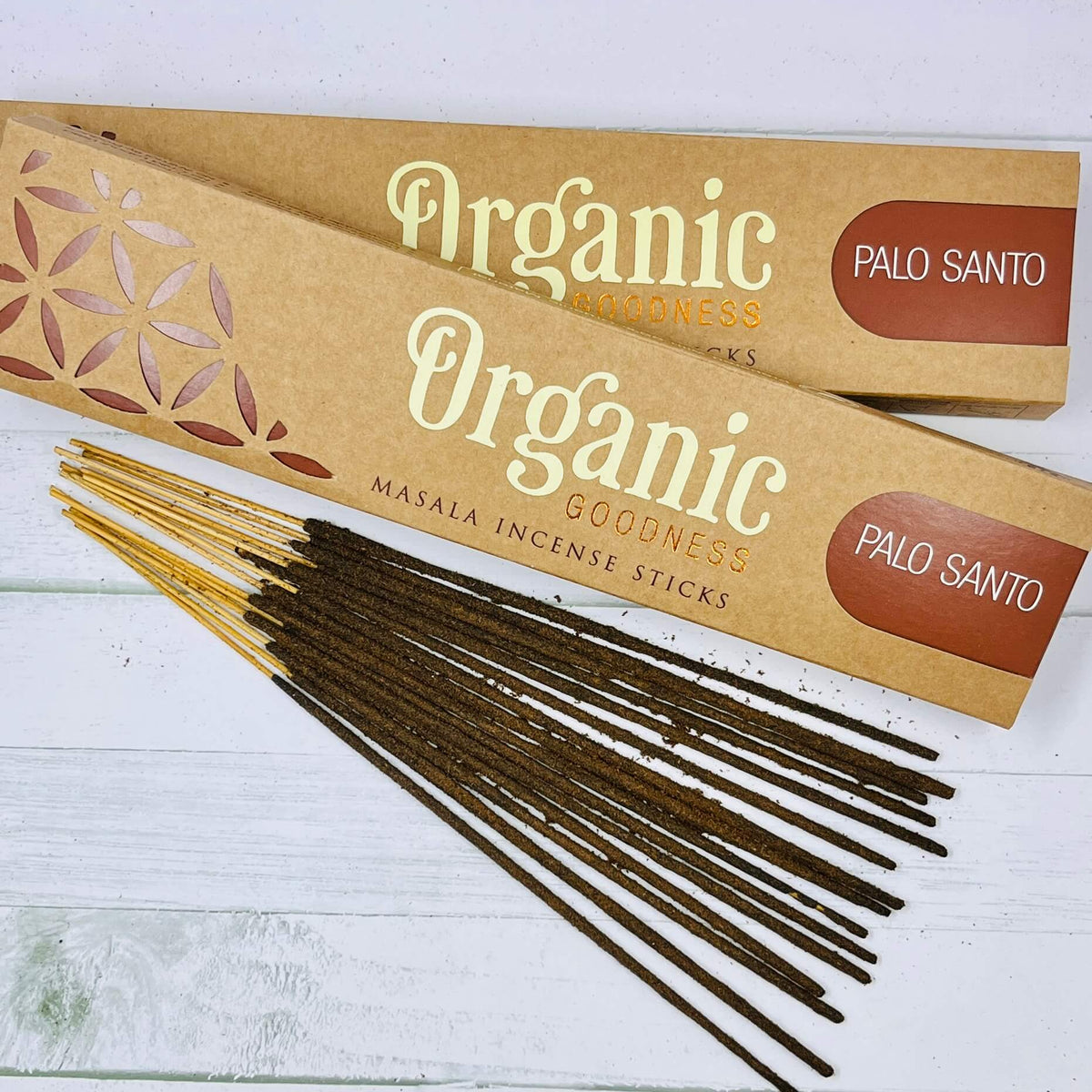 A packet of Organic Goodness Palo Santo incense sticks displayed on a wooden surface.