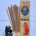 A packet of incense sticks labeled 'Night Queen' with a red graphic of a woman on the front, along with natural elements like herbs and flowers displayed around.