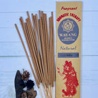 A packet of Balinese Sandalwood Incense with 20 sticks displayed in front of the packet. The incense sticks are beige, and there are decorative elements like dried flowers and leaves included.