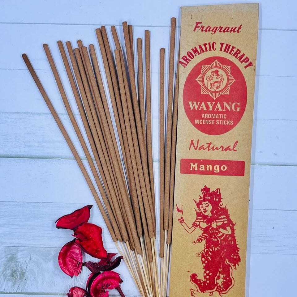 A packet of Balinese Mango incense sticks with 20 sticks displayed in front of the packet. There are also some dried flowers next to the incense sticks.