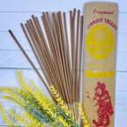 A packet of Balinese Nag Champa incense sticks displayed alongside a sprig of herbs.