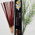 A packet of Banjara Aztec incense sticks with Dragons Blood fragrance, displayed alongside decorative foliage.