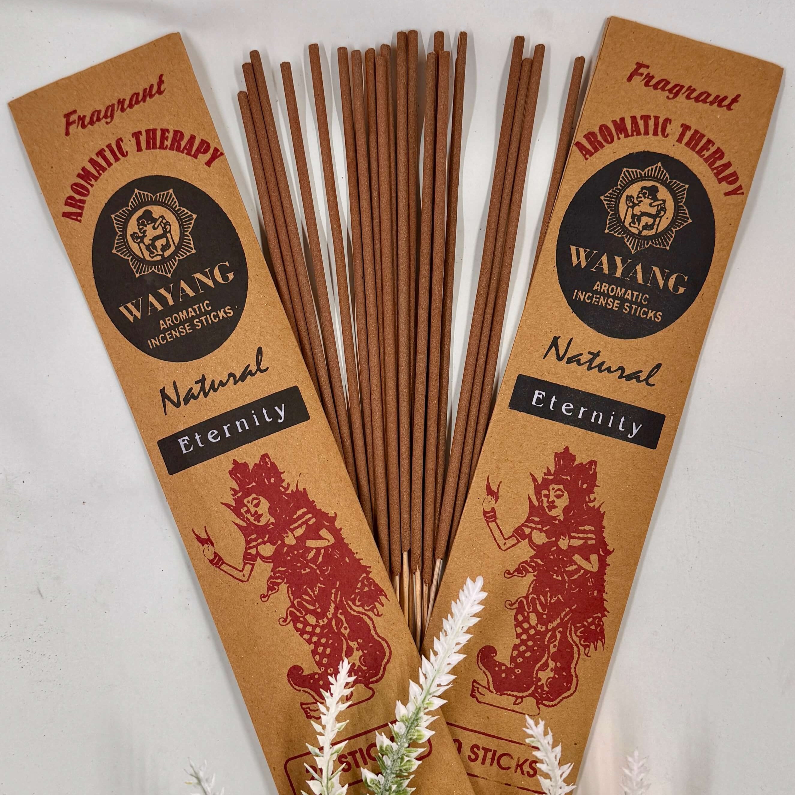 A bundle of Balinese Eternity incense sticks with brown packaging that has red and white text, and a decorative element in the background.