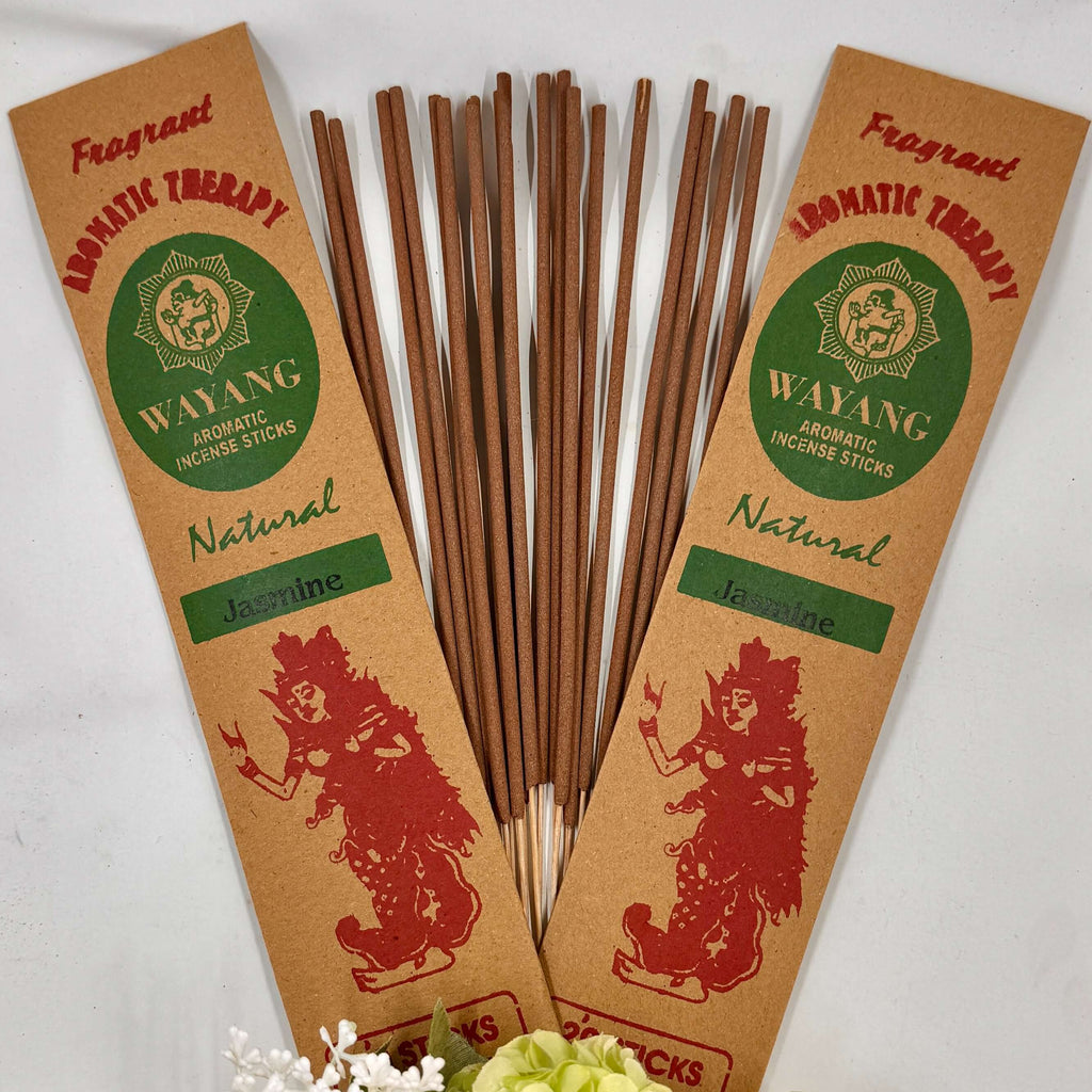 A collection of incense sticks with jasmine fragrance, labeled 'Wayang', arranged in a fan-like spread against a white background, with a bundle of white flowers to the side.
