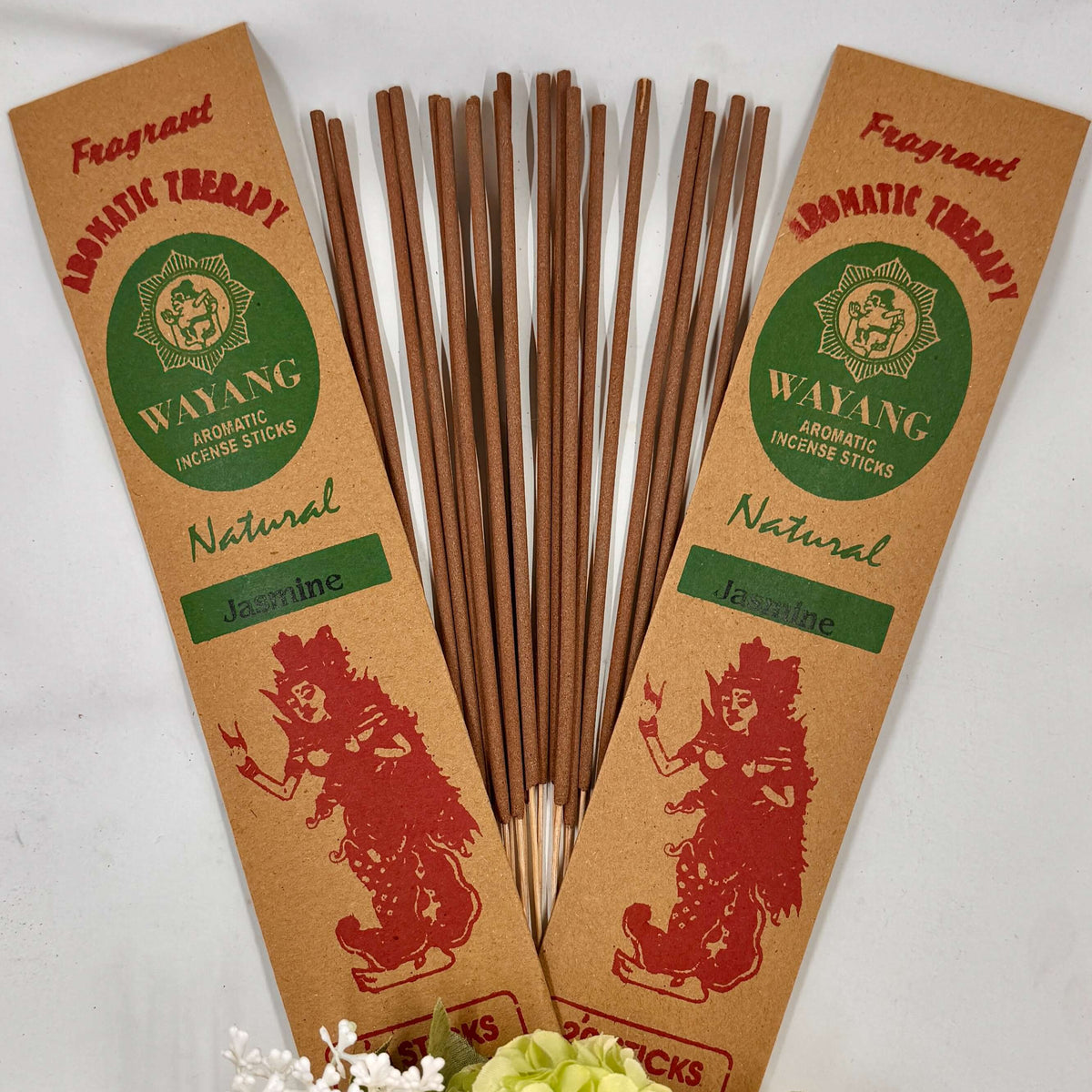 A collection of incense sticks with jasmine fragrance, labeled 'Wayang', arranged in a fan-like spread against a white background, with a bundle of white flowers to the side.