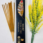 A packet of Banjara Aztec incense sticks with Cedar Pine fragrance, displayed alongside decorative yellow flowers.