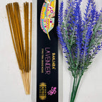 A packet of Banjara Aztec incense sticks with lavender color displayed next to a sprig of lavender.