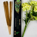 A packet of Banjara Aztec Eucalyptus incense sticks displayed alongside green and yellow floral decor.