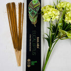 A packet of Banjara Aztec Eucalyptus incense sticks displayed alongside green and yellow floral decor.