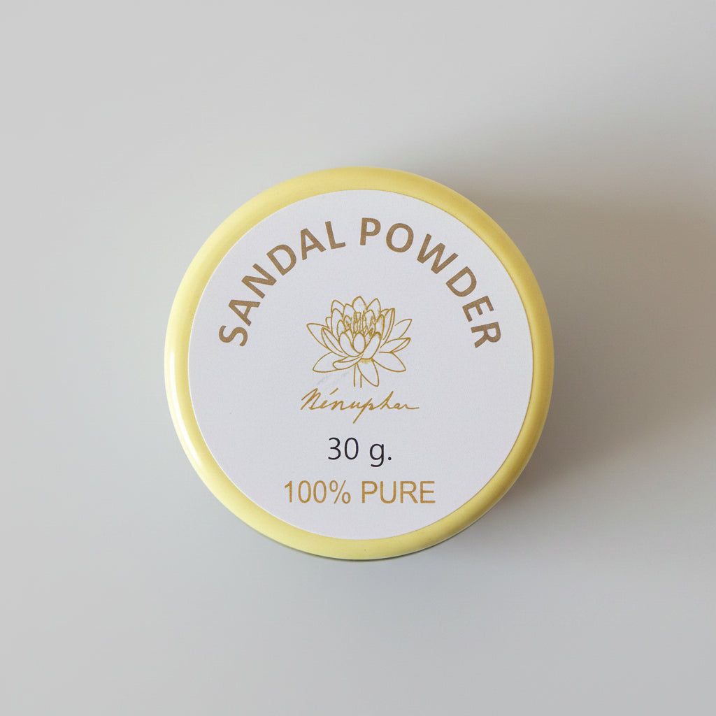 A round tin of Menugha Sandal Powder, 30g, with a yellow rim and a white label, placed on a dark brown wooden surface.