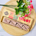 Handmade incense cones from Sagrada Madre displayed next to rose petals and a floral decoration, with the product packaging in the background.