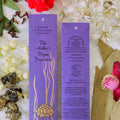 Two purple rectangular fragrance boxes for 'The Mother's Vegan Fragrances' by 'Jasmine & Yong lang Nagchampa' are displayed on a white background decorated with white flowers, green leaves, dried herbs, and red blossoms.