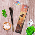 A packet of Sacred Elements NEW BEGINNINGS Manifestation Incense displayed alongside mint leaves, camphor crystals, and a wooden surface.