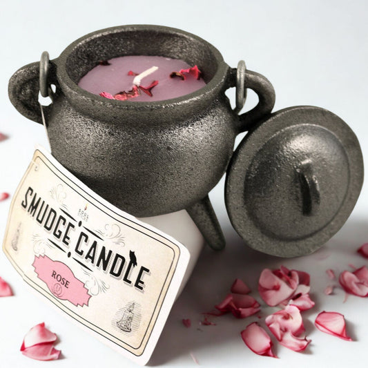 Smudge candle in a black pot with rose petals on a white background