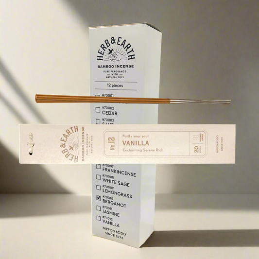 Herb & Earth bamboo incense packaging with incense sticks on a white background