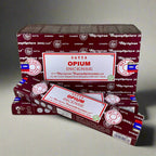 Two boxes of Satya Opium Incense on a textured surface