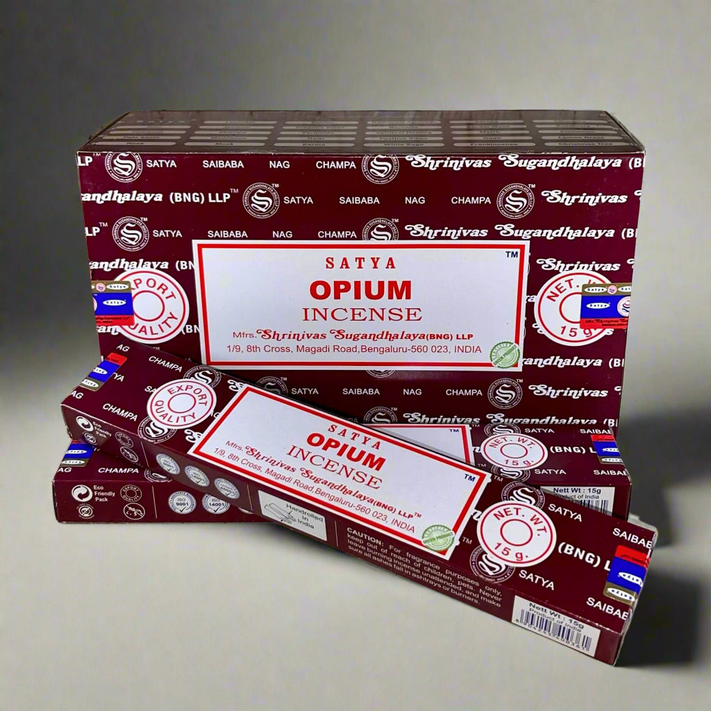 Two boxes of Satya Opium Incense on a textured surface